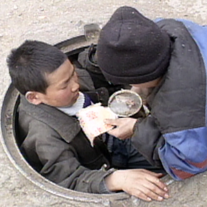 Manhole children sharing their food.
